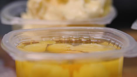 close-up of canned pineapple preserves in plastic containers