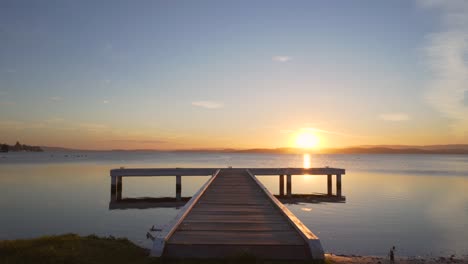 sunset in small lake with t shape jetty