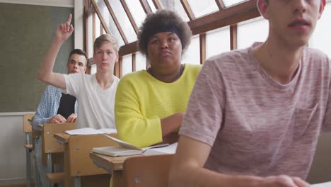 student raising his hand in class