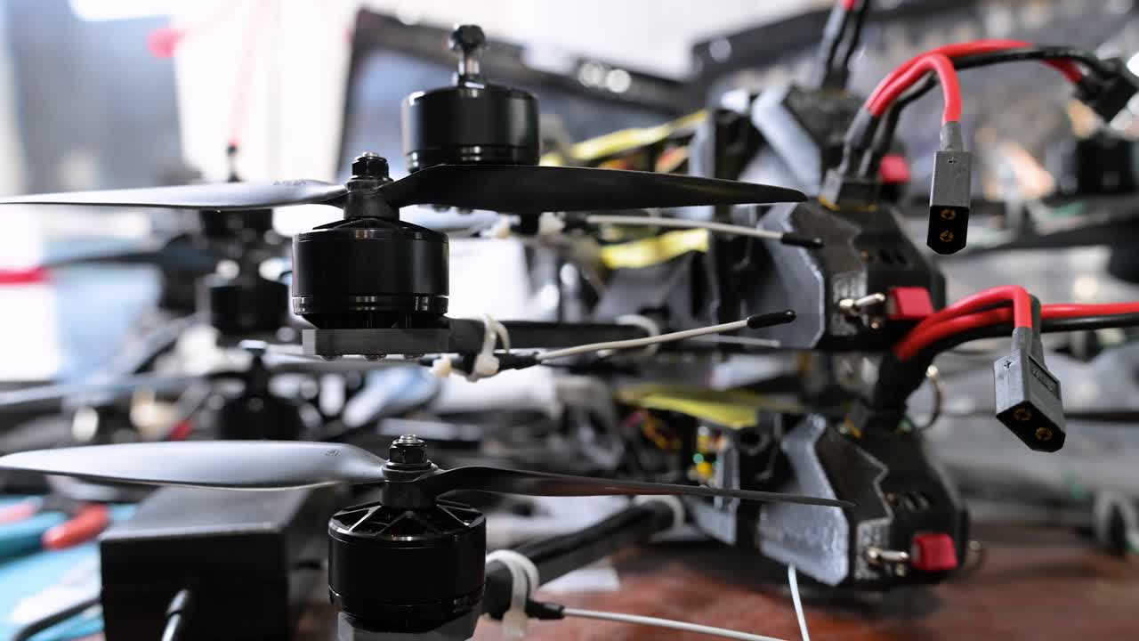 This close-up shot shows civilian drone technology being repurposed for military use in Ukraine, as soldiers assemble FPV drones into combat-ready assets for the war with Russia