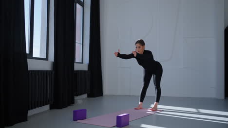 woman practicing yoga in a studio