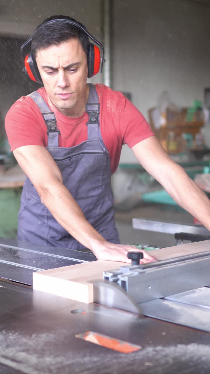 Man cutting wood with a table saw in a workshop