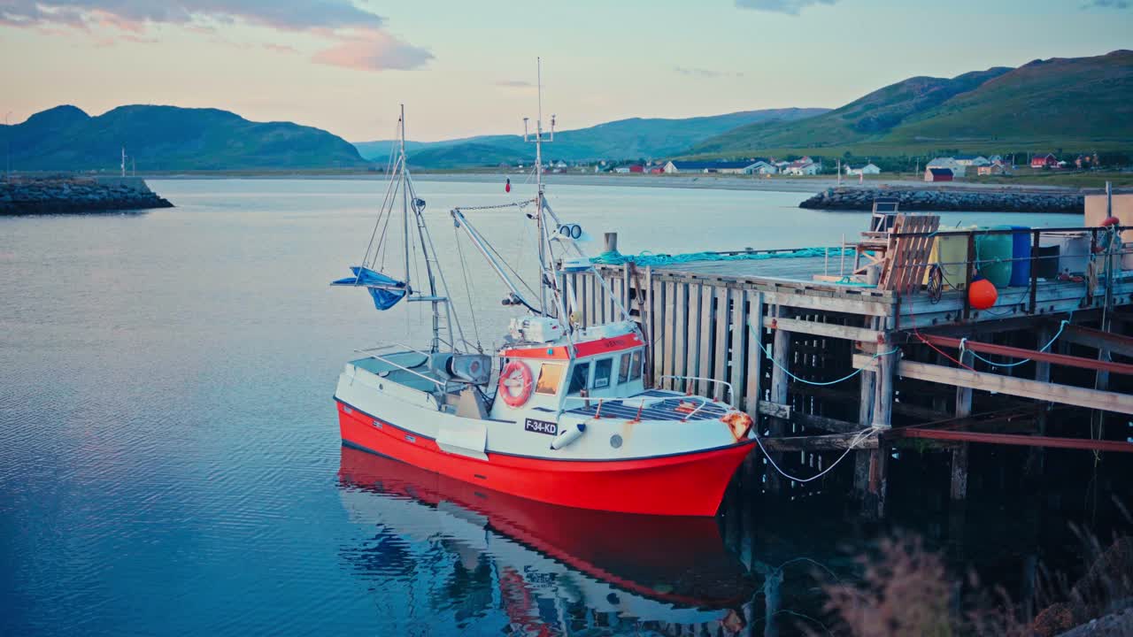 Kokelv, Hammerfest, Finnmark, Norway - A Red and White Fishing Boat Rests Peacefully at the Wooden Dock, Surrounded by Calm Coastal Waters - Medium Shot