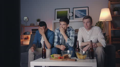 friends watching a disappointing game