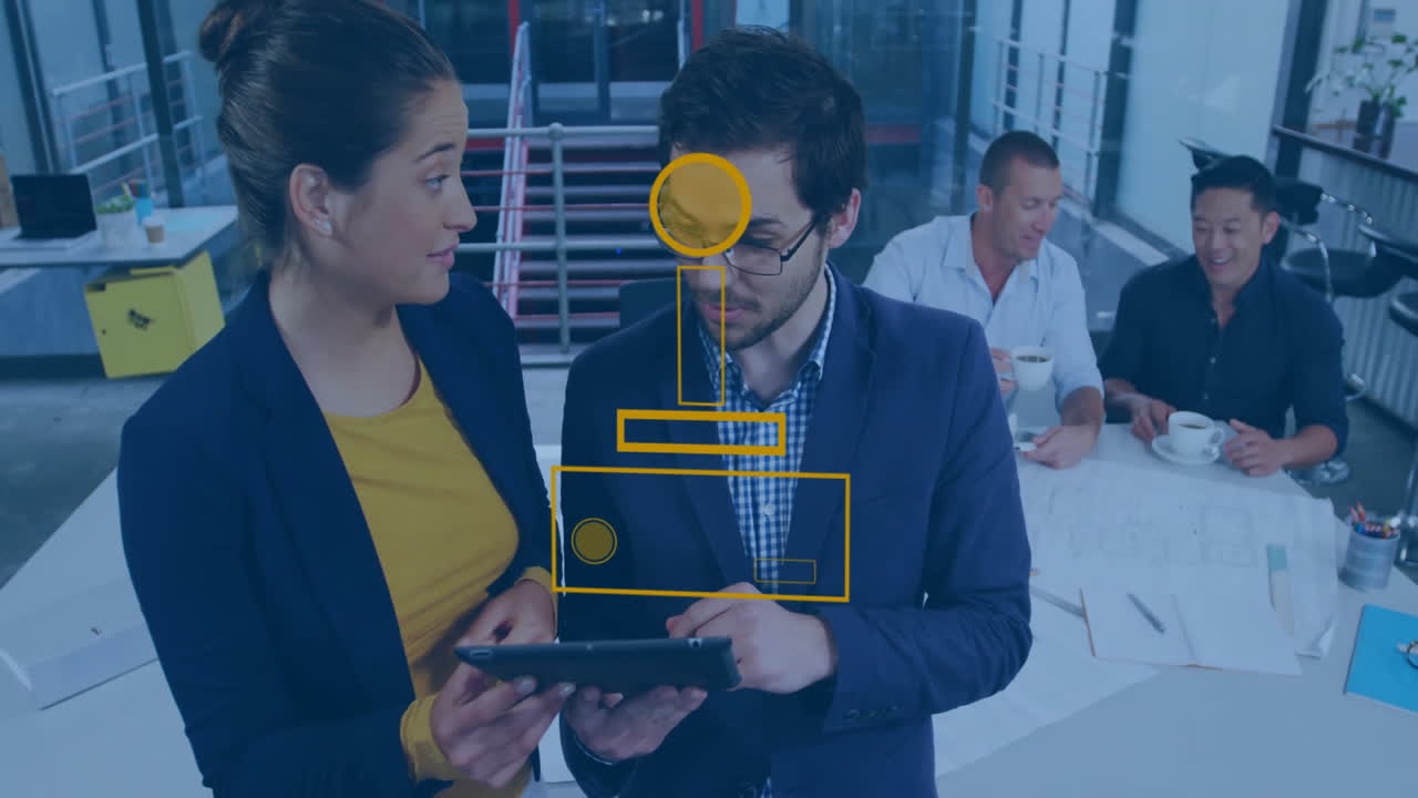 Discussing over tablet, business professionals with geometric animation overlay in office