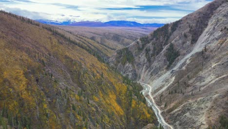 Aerial-backward-above-Burwash-Creek,-Kluane-National-Park,-British-Columbia