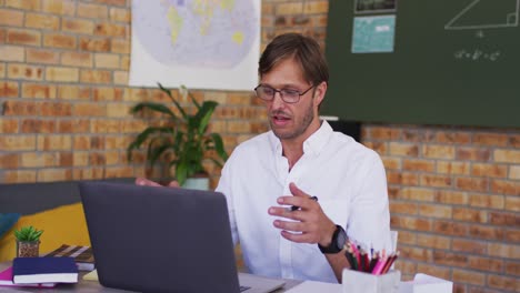 Profesor-Caucásico-Enseñando-En-Videollamada-En-Una-Computadora-Portátil-En-El-Aula-De-La-Escuela