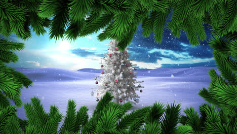 green christmas branches over snow falling over christmas tree on winter landscape