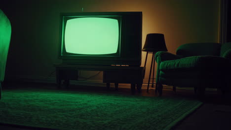 retro green screen tv in a dark living room