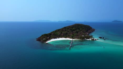 koh kham island with its green tropical vegetation surrounded by crystal clear turquoise waters, thailand. wonderful aerial view flight drone shot footage from above