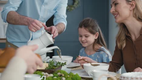 Vater-Gießt-Tee-Während-Des-Osteressens-Ein.