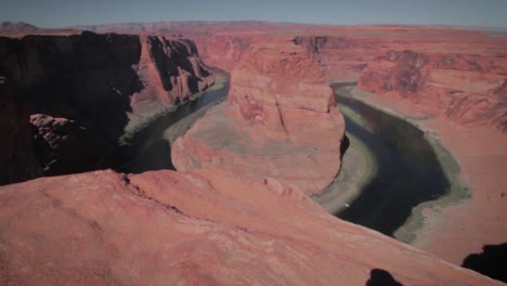 flowing colorado river creating horseshoe bend in arizona at noon located near the town page