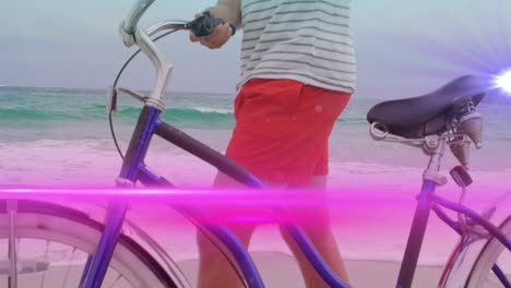 Animation-of-pink-light-beam-moving-over-man-wheeling-bicycle-on-beach