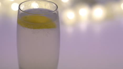 glass cup with sparkling water and lemon