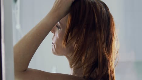 close-up-shot-of-a-lady-loosening-her-hair-after-her-make-up