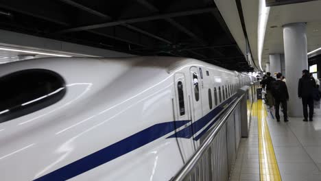 passengers boarding and alighting a bullet train