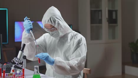 doctor in protective suit is doing a science experiments and developing vaccine in a modern lab. laboratory assistant workplace. the concept of science and medicine