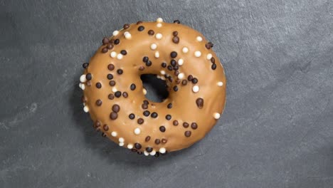 sweet donut rotates on a dark background. traditional american sweetness