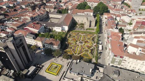 aerial circular view of braga city center, with people walking by and flowerbeds