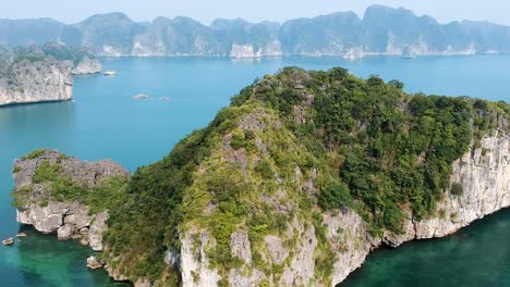 Aerial-drone-shot-over-Ha-Long-Bay,-blue-sea-and-limestone-islands-of-Lan-ha-bay