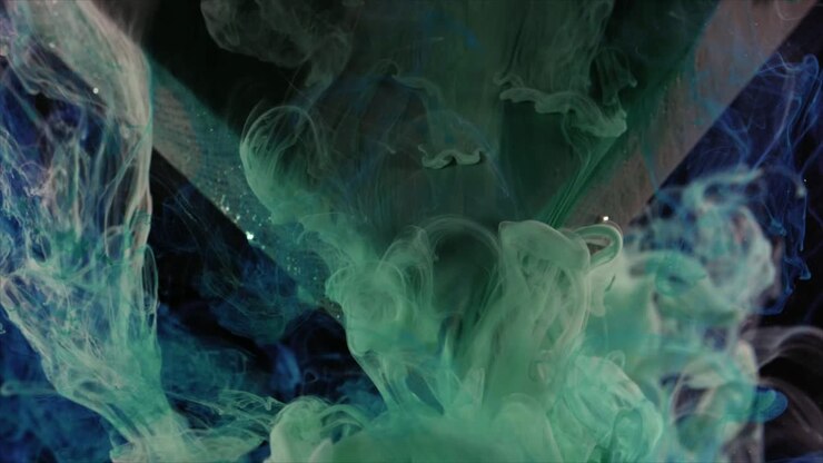 Vibrant Green and Blue Ink Mixing in Dark Water