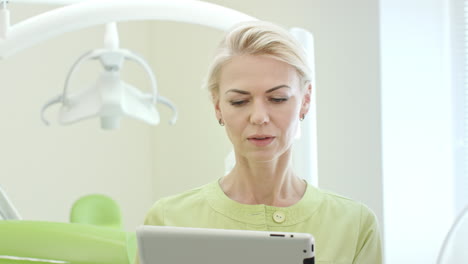 woman dentist using tablet computer. dental professional using tablet pc