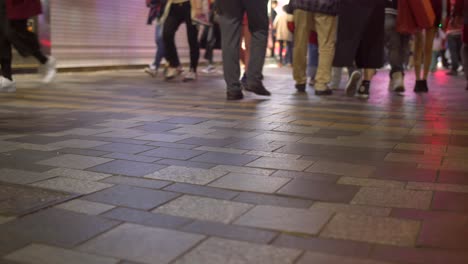 legs of pedestrians on sidewalk