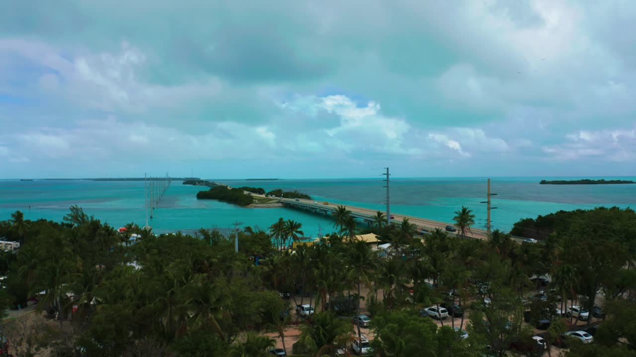 Aerial drone 4K UHD footage of the famous Highway One leading from Miami Beach all the way down to Key West in Florida. The turquoise Atlantic Ocean is  surrounding the hundreds of coral reef islands