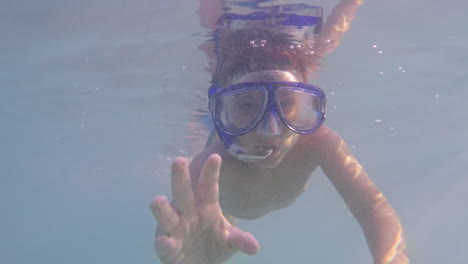 underwater footage of toddler bot snorkelling and reach out for his father's hand at sea of kalamata,greece