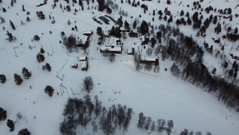 aerial drone flyover snow covered norwegian lodging rondane, norway