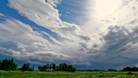 Timelapse-shot-of-white-cloud-movement-over-green-grasslands-throughout-the-day