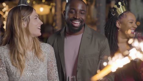 Medium-Shot-of-Some-Friends-Celebrating-New-Years-Eve-with-Champagne-and-Sparklers