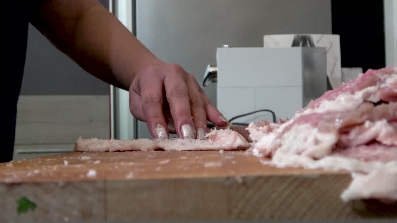 Cutting Pork on a Wooden Board
