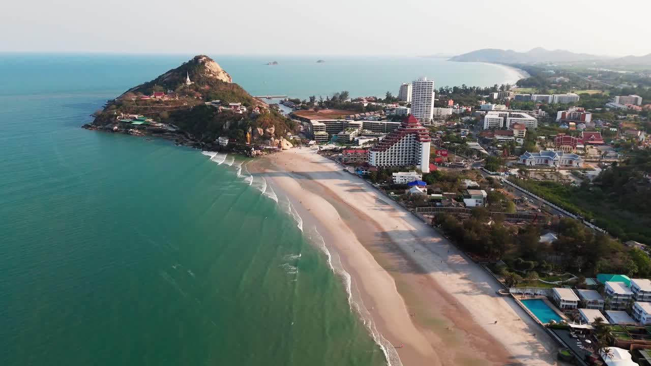 Thailand Aerial establishing of Hua Hin beach coastline with hotels at sunrise, sandy tropical beaches