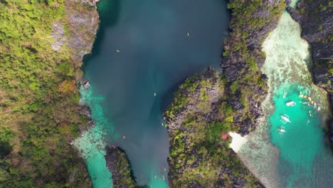 4k drone video of big lagoon, a popular tourist destination near el nido in palawan, philippines. this is an arial view looking down on the stunning natural landscape around the lagoon.