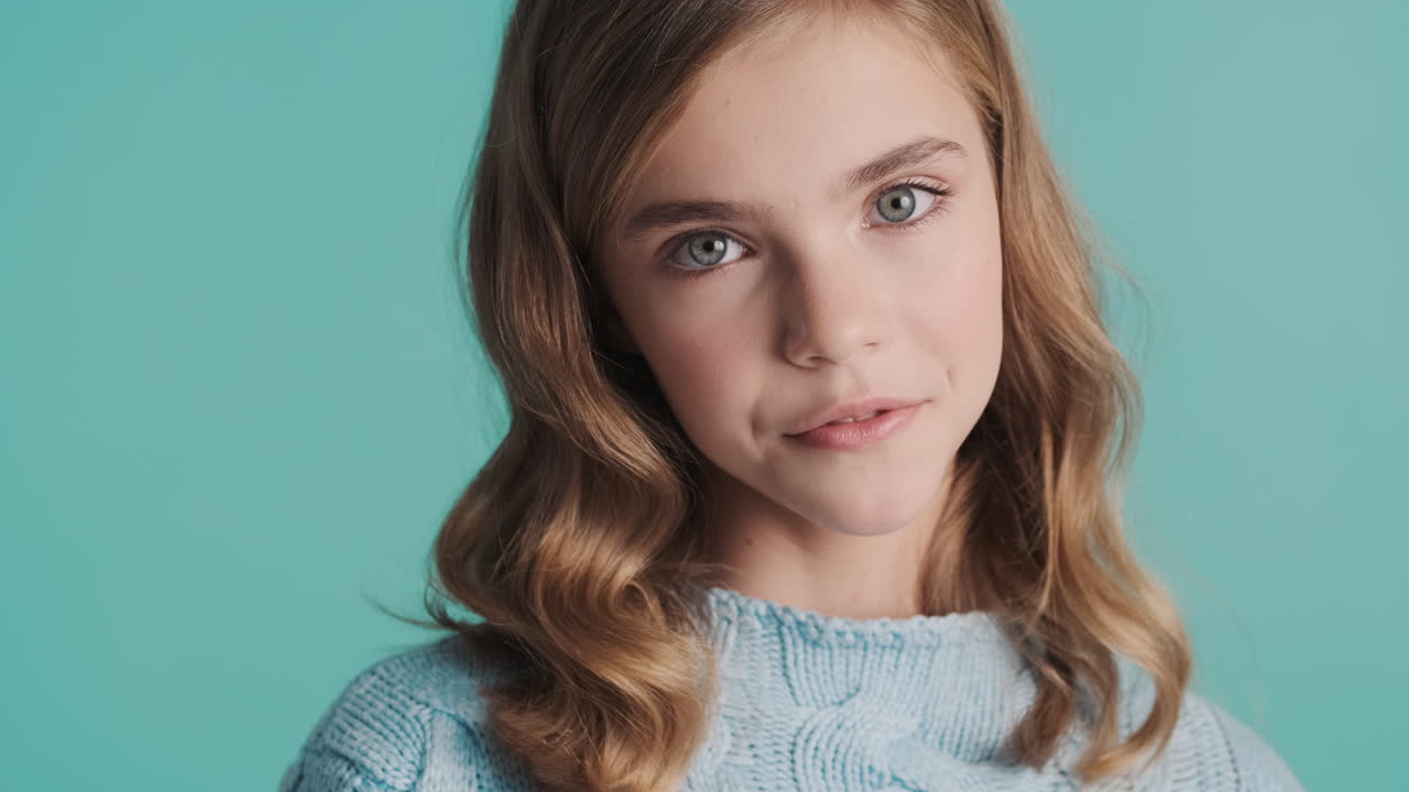 Happy teenage Caucasian girl in front of the camera.