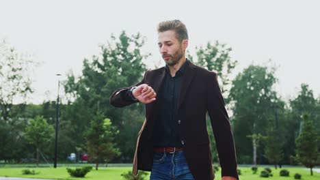 man checking time in park