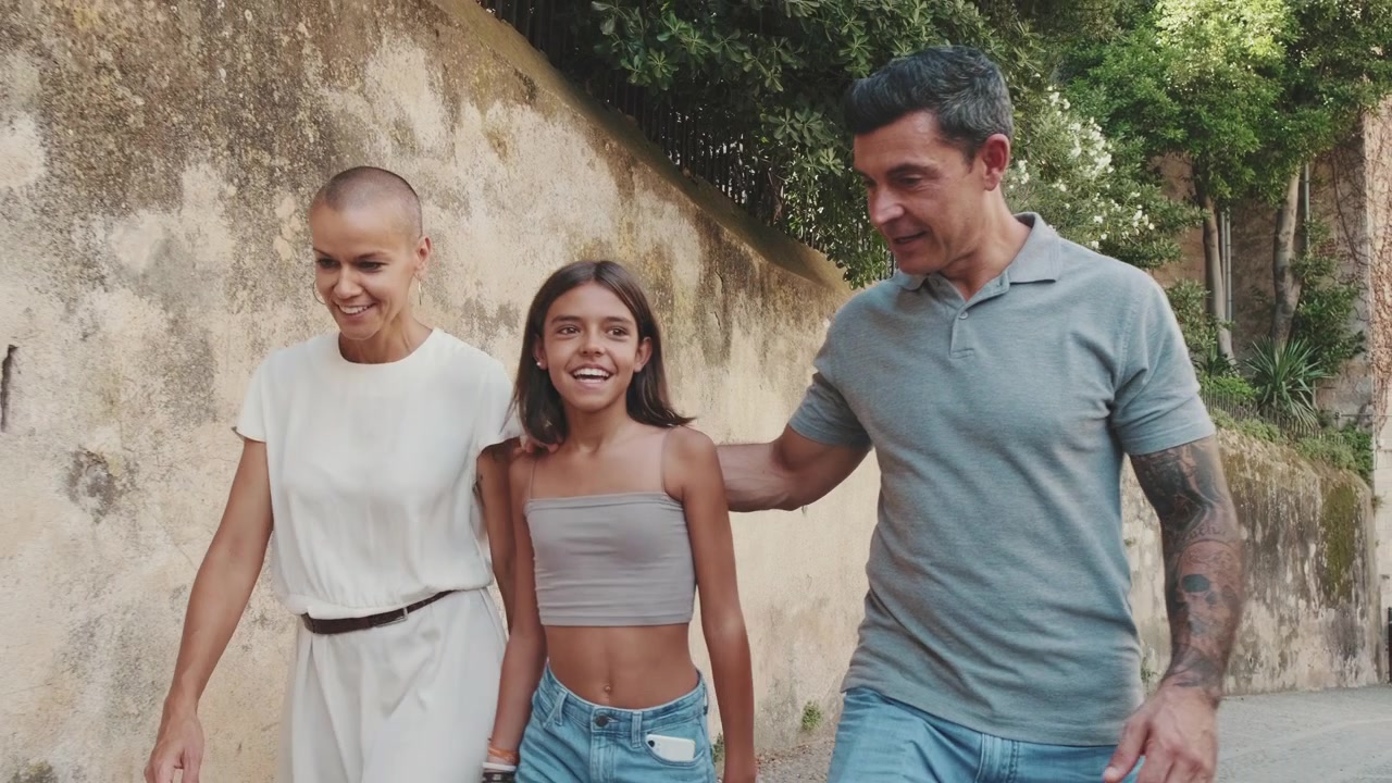 Happy Family Walking Together Outdoors on a Sunny Day