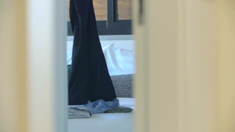 lifestyle image of a young woman folding laundry