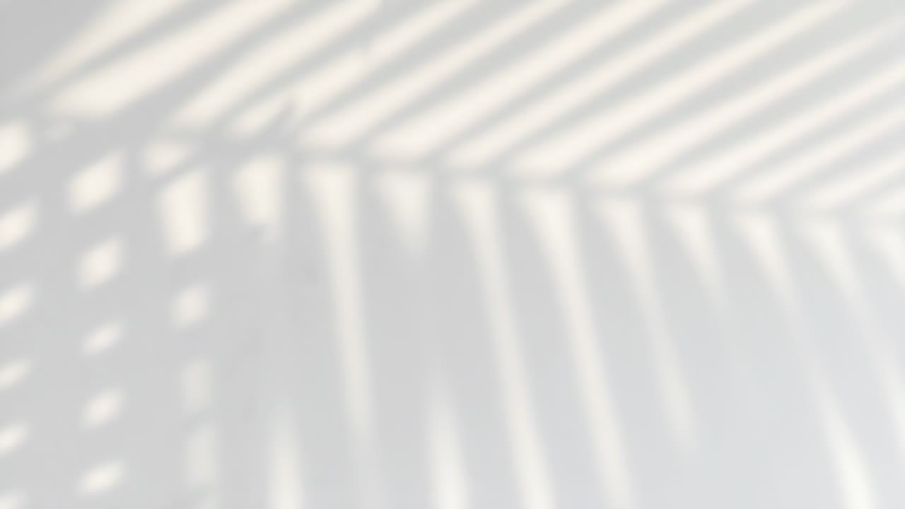 Abstract video concept with soft shadows and light patterns on a white wall