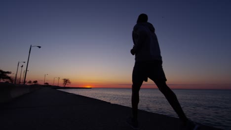 ethnic male silhouette running at sunrise for fitness