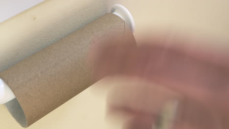 person frustrated at empty toilet roll, close up