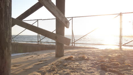 seal beach pier and pacific ocean with chainlink fence