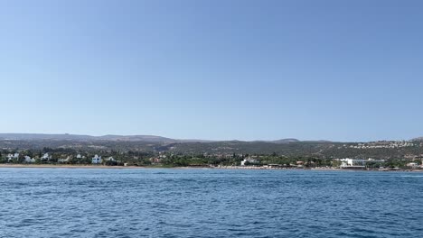 View from boat sailing in the large blue sea near the coastline of the long island in hot weather