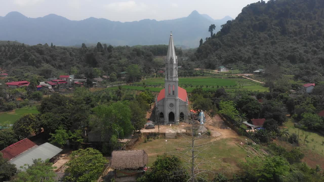Flying backwards at White Catholic Church at Tuy&ecirc;n Quang Vietnam, aerial