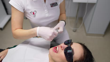 woman patient having dental treatment. beautiful young woman doing tooth examination in the dental office