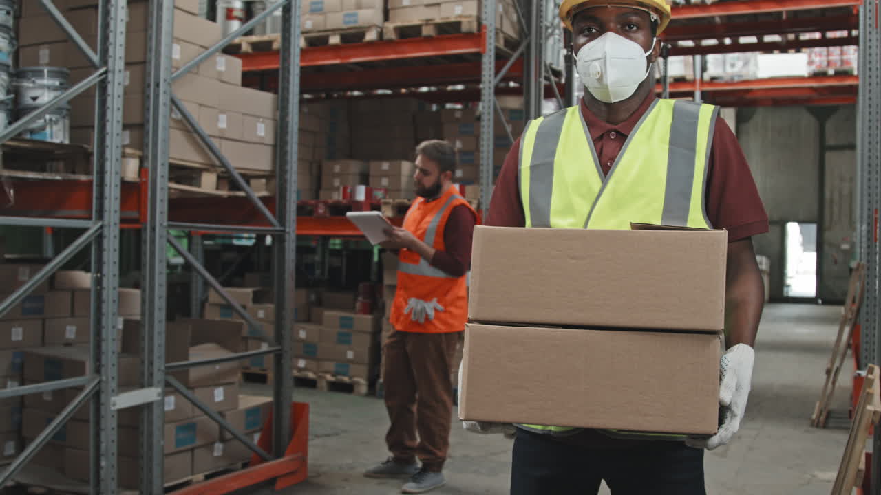 African-American Male Worker Posing in Warehouse