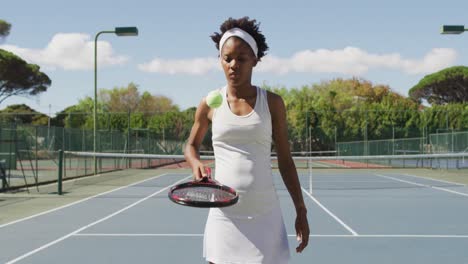 video of african american female tennis player holding racket and bouncing ball