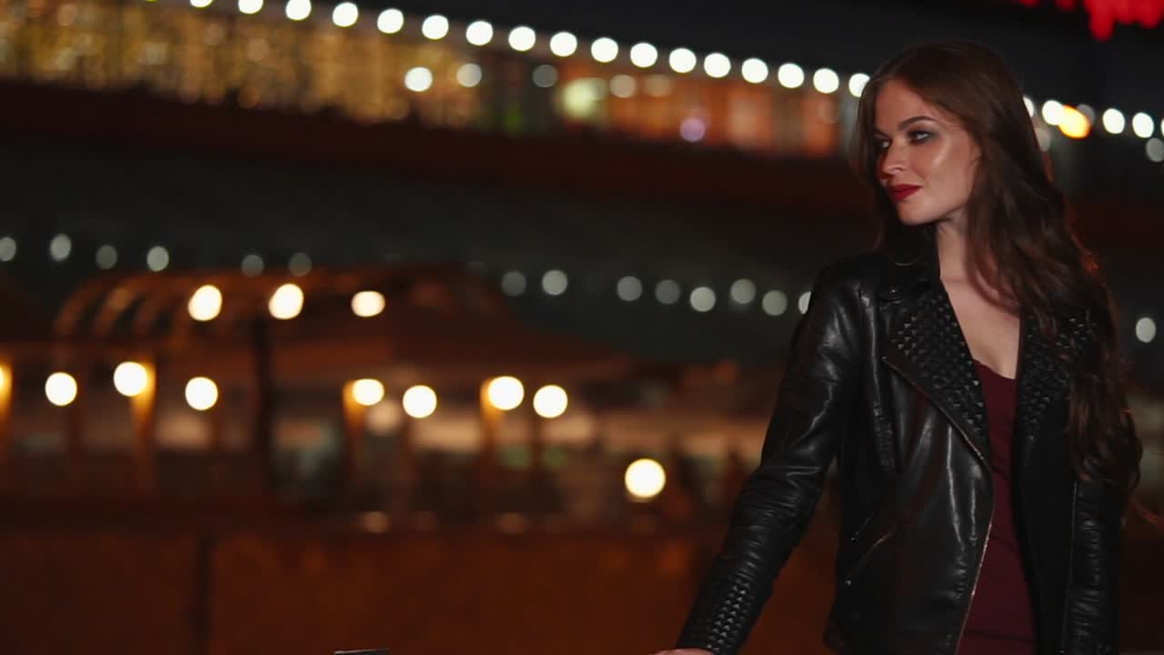 Woman in Leather Jacket at Night