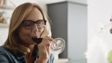 Handheld-video-of-woman-drinking-wine-at-home